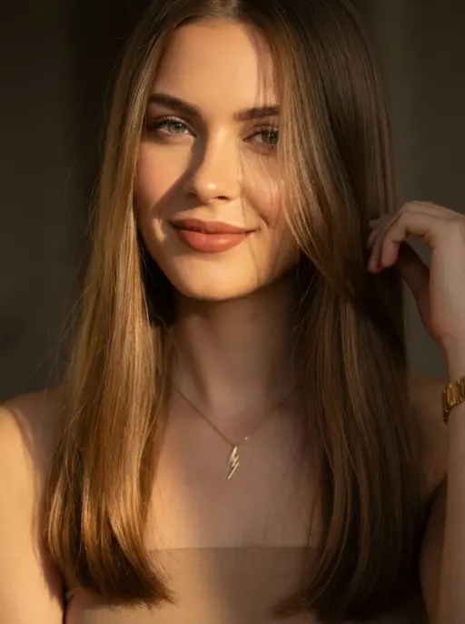 A cinematic close-up portrait of a young woman with long straight light brown ha...