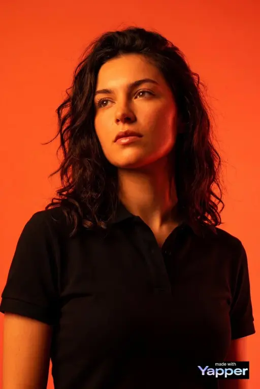 Create a high-impact editorial studio portrait using the person from the attache...